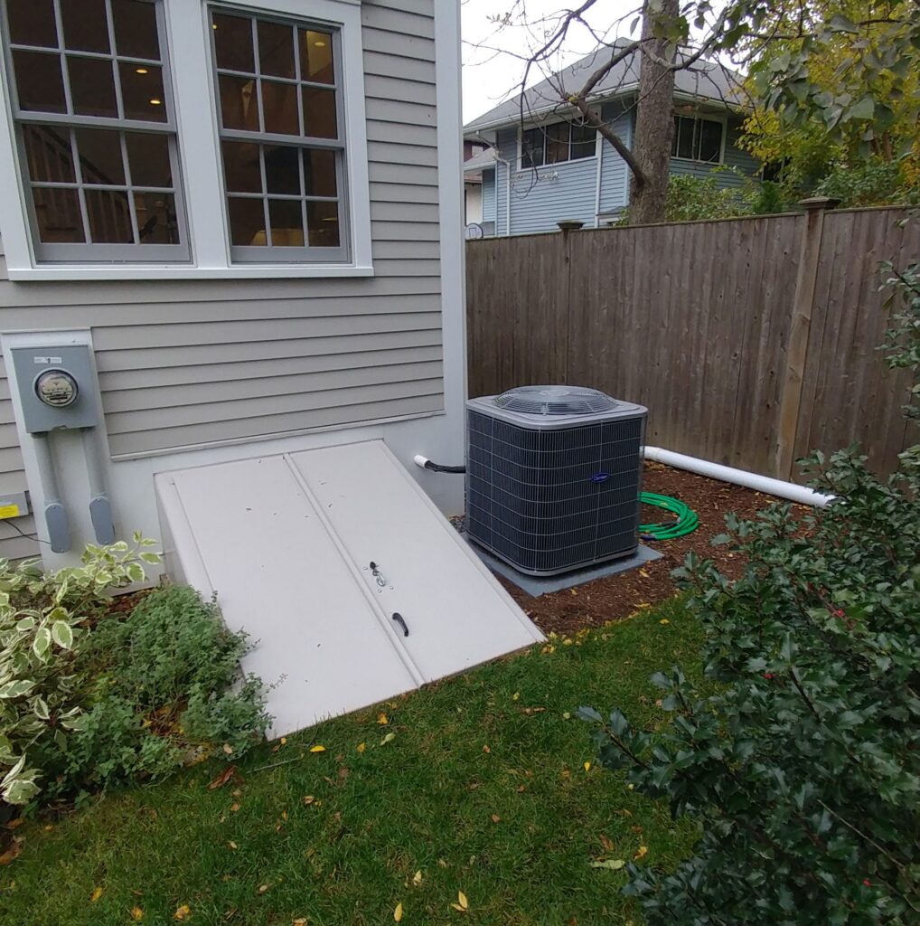 A residential air conditioning condenser unit beside an East Texas home